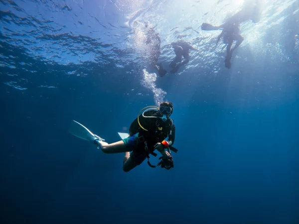 Advanced diver with personal gear and underwater camera